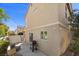 Exterior home view featuring a grill, outdoor seating, neutral stucco, and a fenced patio space, perfect for entertaining at 10468 Concetta Ave, Las Vegas, NV 89129