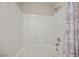 Bright tiled bathtub and shower combination featuring a white-tiled surround and neutral patterned shower curtain at 10468 Concetta Ave, Las Vegas, NV 89129