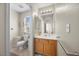 Well-lit bathroom featuring neutral tile flooring, toilet, white countertop, and a cabinet with storage at 10468 Concetta Ave, Las Vegas, NV 89129
