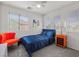 Inviting bedroom with great natural light, neutral walls, plush carpeting, and stylish orange accents at 10468 Concetta Ave, Las Vegas, NV 89129