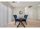 Bright dining area with a glass-top table, seating for four, and sliding glass doors providing natural light at 10468 Concetta Ave, Las Vegas, NV 89129