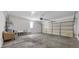 Spacious garage with a water heater, seating, and painted concrete flooring at 10468 Concetta Ave, Las Vegas, NV 89129