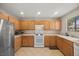 Functional kitchen featuring ample counter space, modern appliances, and light wood cabinets at 10468 Concetta Ave, Las Vegas, NV 89129