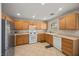 Bright kitchen featuring light wood cabinetry, stainless steel appliances, and tile flooring at 10468 Concetta Ave, Las Vegas, NV 89129