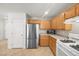 Functional kitchen featuring stainless steel appliances, ample counter space, and light wood cabinets at 10468 Concetta Ave, Las Vegas, NV 89129