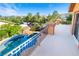 Balcony view of sparkling pool, rock waterfall, and lush greenery perfect for outdoor relaxation and entertainment at 10798 Tapestry Winds St, Las Vegas, NV 89141