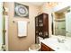 Functional bathroom with a sink, toilet, cabinet, decorative artwork and a shower with glass door at 10798 Tapestry Winds St, Las Vegas, NV 89141