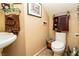 Small bathroom with tan wall, ornate decor, and toilet at 10798 Tapestry Winds St, Las Vegas, NV 89141
