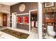 Spacious bathroom featuring mosaic tile accents, walk-in closet, and toilet at 10798 Tapestry Winds St, Las Vegas, NV 89141