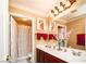 Bathroom with a double vanity, framed mirrors, and framed art at 10798 Tapestry Winds St, Las Vegas, NV 89141