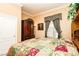 Cozy bedroom featuring a floral patchwork quilt, natural light, and classic furnishings at 10798 Tapestry Winds St, Las Vegas, NV 89141