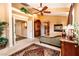 A bedroom is shown with a sitting area, armoire, and many windows at 10798 Tapestry Winds St, Las Vegas, NV 89141