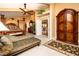 A bright bedroom is shown with sitting area and nice furniture at 10798 Tapestry Winds St, Las Vegas, NV 89141