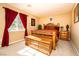 Cozy bedroom with warm lighting, a wooden bed frame, side tables, and a chest at 10798 Tapestry Winds St, Las Vegas, NV 89141