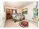 Bedroom featuring an iron bed frame, an ocean themed painting and a decorative glass topped table at 10798 Tapestry Winds St, Las Vegas, NV 89141