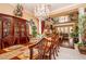 Elegant dining room with chandelier and dining table with seating for eight at 10798 Tapestry Winds St, Las Vegas, NV 89141
