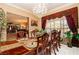 Elegant dining room with chandelier and dining table with seating for eight at 10798 Tapestry Winds St, Las Vegas, NV 89141
