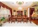 Elegant dining room featuring a chandelier, large window, and ornate decor at 10798 Tapestry Winds St, Las Vegas, NV 89141