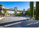 Gated community entrance with decorative stone towers and lush landscaping at 10798 Tapestry Winds St, Las Vegas, NV 89141