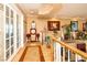 Bright hallway with hardwood floors, decorative plants, and elegant furnishings at 10798 Tapestry Winds St, Las Vegas, NV 89141