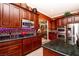 Modern kitchen features dark wood cabinets, stainless steel appliances and tiled floor at 10798 Tapestry Winds St, Las Vegas, NV 89141