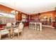 Open kitchen with dark wood cabinets, stainless appliances and breakfast nook at 10798 Tapestry Winds St, Las Vegas, NV 89141