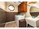 Efficient laundry room setup with washer, dryer, sink, and overhead cabinets at 10798 Tapestry Winds St, Las Vegas, NV 89141