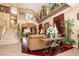 Open-concept living room with high ceilings, a grand staircase, and elegant décor, creating a luxurious ambiance at 10798 Tapestry Winds St, Las Vegas, NV 89141
