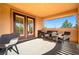 Spacious covered patio with seating area and large windows that bring in ample natural light at 10798 Tapestry Winds St, Las Vegas, NV 89141