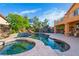 Large backyard swimming pool with integrated jacuzzi and mature landscaping in a private backyard at 10798 Tapestry Winds St, Las Vegas, NV 89141