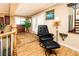Cozy second story sitting area with wood floors and black leather chair at 10798 Tapestry Winds St, Las Vegas, NV 89141