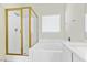 Bathroom featuring a bathtub with a glass enclosed shower and marble countertops at 11076 Zampino St, Las Vegas, NV 89141