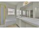 Bathroom featuring a large bathtub, tiled floors, shower and marble countertops at 11076 Zampino St, Las Vegas, NV 89141