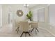 Bright dining area features tile flooring, large windows, and seating for four near the home's entryway at 11076 Zampino St, Las Vegas, NV 89141