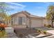 Single-story home with a well-maintained yard and an attached two-car garage at 11076 Zampino St, Las Vegas, NV 89141