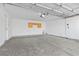 Spacious garage with overhead door, ample space, and a wall storage unit at 11076 Zampino St, Las Vegas, NV 89141