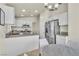 Open kitchen design with granite countertops, stainless steel appliances, and a breakfast bar at 11076 Zampino St, Las Vegas, NV 89141