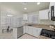 Bright kitchen boasts granite countertops, modern appliances, ample cabinet space and a small eating area at 11076 Zampino St, Las Vegas, NV 89141