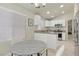 Open-concept kitchen with modern appliances, sleek countertops, and a dining area with seating for four at 11076 Zampino St, Las Vegas, NV 89141