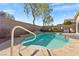 Inviting pool with waterfall feature, lush landscaping, and privacy wall at 11076 Zampino St, Las Vegas, NV 89141