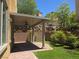 Backyard featuring a covered patio, brick paving and verdant landscaping at 11298 Corsica Mist Ave, Las Vegas, NV 89135