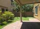 Serene backyard featuring a covered patio, manicured lawn, and lush greenery at 11298 Corsica Mist Ave, Las Vegas, NV 89135