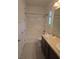 Bright bathroom featuring dual sinks, dark wood cabinetry, and a shower/tub combo at 11298 Corsica Mist Ave, Las Vegas, NV 89135