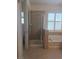 Bright bathroom featuring a soaking tub under shuttered windows and a glass shower at 11298 Corsica Mist Ave, Las Vegas, NV 89135