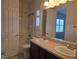 Bright bathroom featuring a double sink vanity and shower-tub combination at 11298 Corsica Mist Ave, Las Vegas, NV 89135