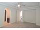 Bedroom featuring neutral carpet, tray ceiling and arched doorways at 11298 Corsica Mist Ave, Las Vegas, NV 89135