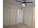 Bedroom with carpet flooring, ceiling fan, and multiple doors at 11298 Corsica Mist Ave, Las Vegas, NV 89135