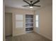 Bedroom features neutral carpet, ceiling fan and a custom display shelf at 11298 Corsica Mist Ave, Las Vegas, NV 89135