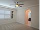 Large bedroom featuring bright windows, carpeted floors, and an arched entry at 11298 Corsica Mist Ave, Las Vegas, NV 89135