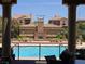 Beautiful community pool area with stone fireplace, picnic tables, and clear blue water at 11298 Corsica Mist Ave, Las Vegas, NV 89135